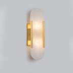 Clérachic brass Olraeia sconce viewed from the side, showing the shallow depth the stone panel sits off the wall