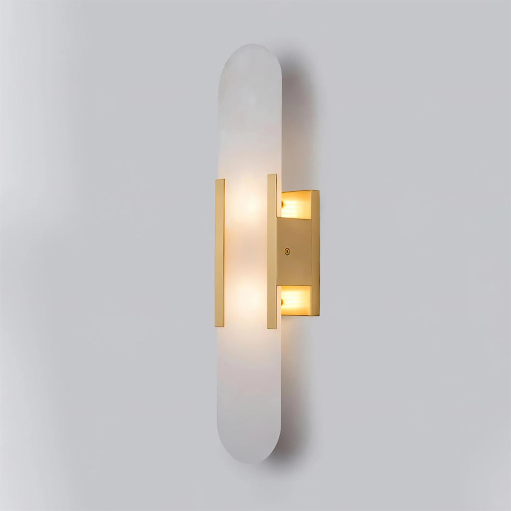 Clérachic slim brass Olraeia sconce angled right on grey, both bulb compartments lit inside the backplate