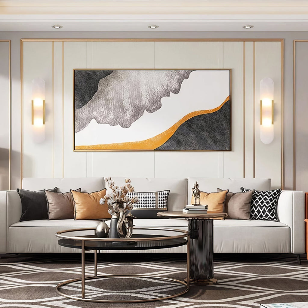 A Clérachic pair of Olraeia sconces flanking a large abstract canvas above a white sofa in a formal living room