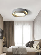 White cylinder ceiling light lit warm in a room