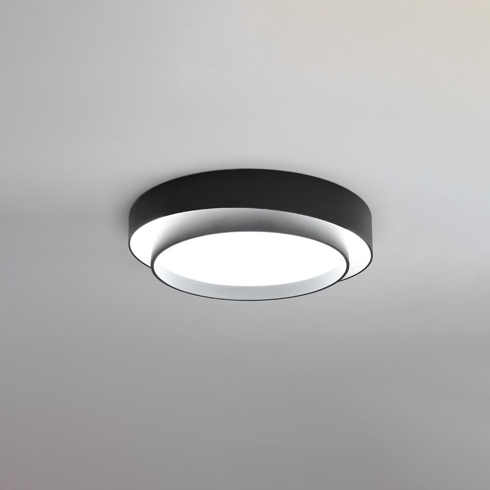 Cylinder ceiling light glowing softly in a modern room
