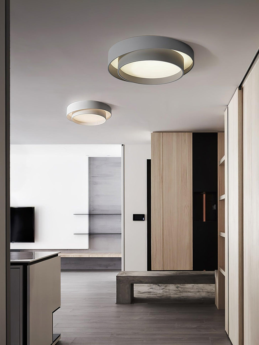 Cylinder ceiling light lit warm against the ceiling