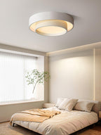 Modern cylinder ceiling light glowing in a living room