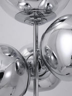 A close-up of the chrome mounting rod and discs joining this Clérachic floor lamp's mirror-chrome globes into their clustered arrangement.