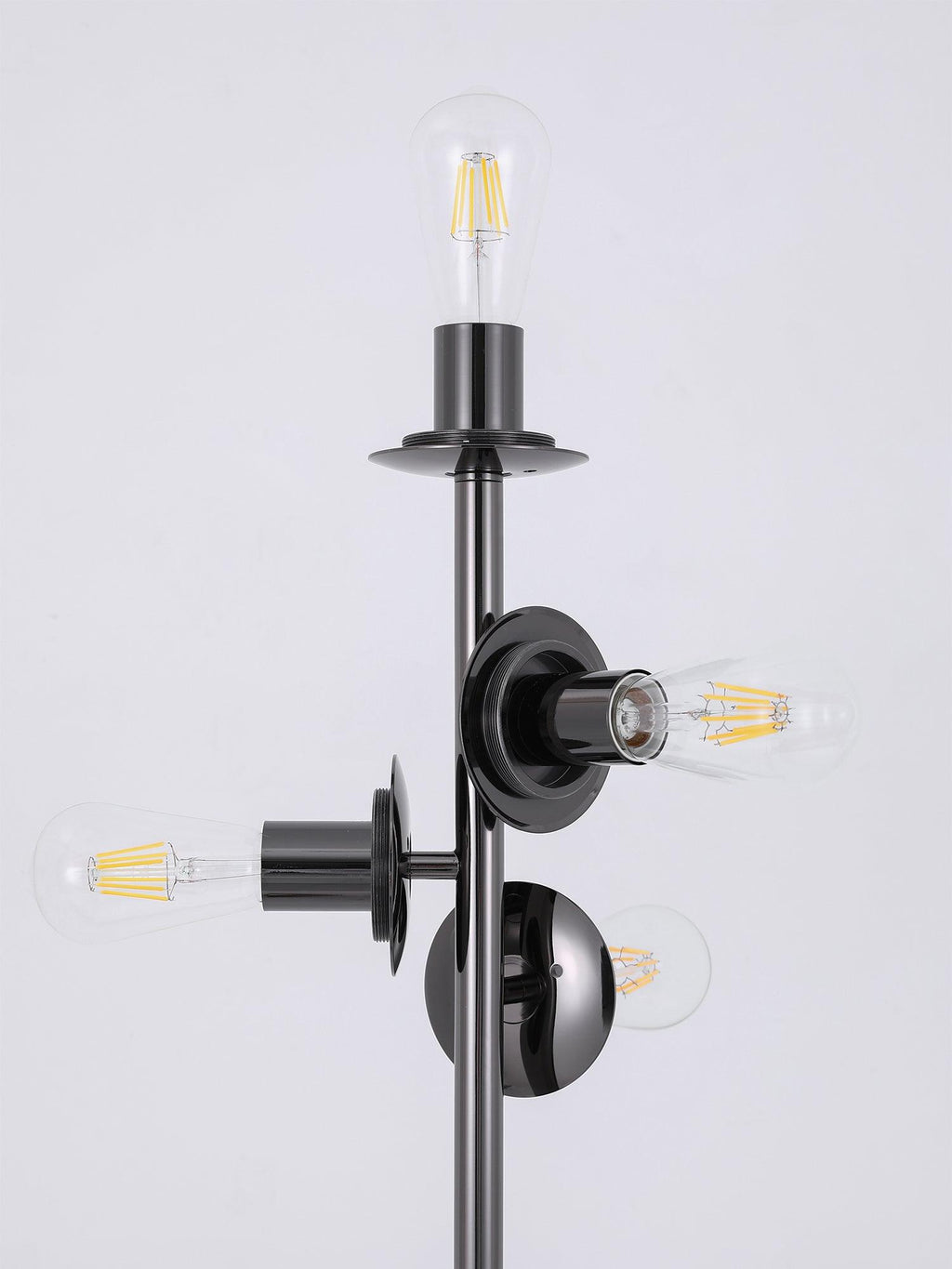 Close-up of the black-finish socket fittings on this Clérachic floor lamp, bare filament bulbs exposed with the glass globes removed.