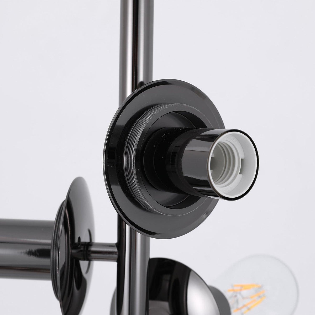 Close-up of a single empty black-finish socket on this Clérachic floor lamp, its threaded fitting mounted on the slender chrome rod.