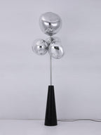 Unlit mirror-chrome glass globes catch the studio light on this Clérachic floor lamp, shown plain against a white background with its cord.