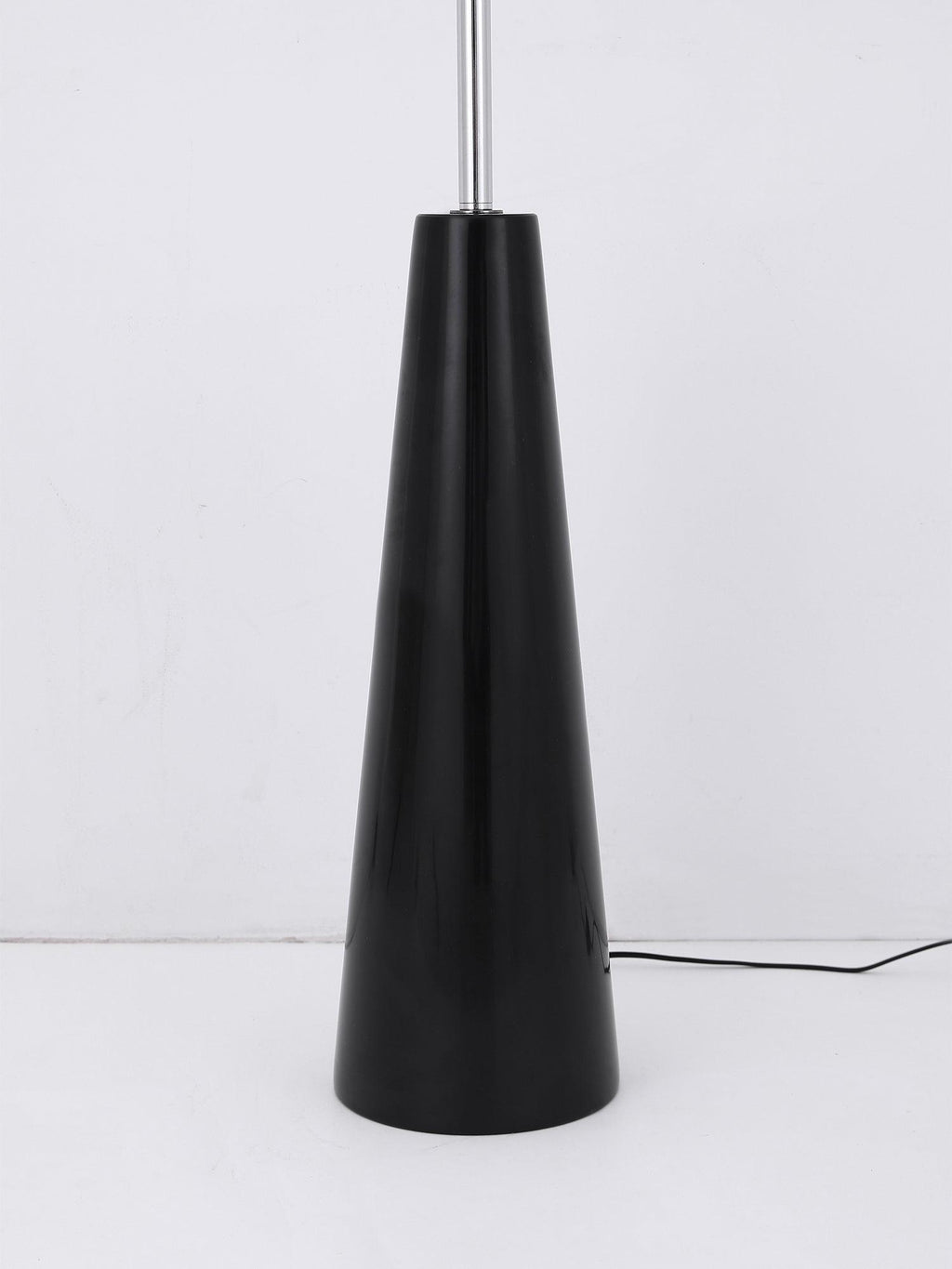 The plain black conical base of this Clérachic floor lamp shown alone, its glossy lacquered finish visible with no globes attached.