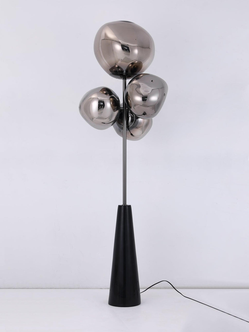 Clérachic floor lamp shown unlit and square-on against a pale backdrop, its mirror-chrome globes and black conical base fully visible.