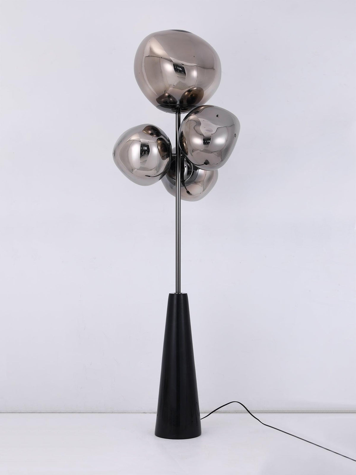Clérachic floor lamp shown unlit and square-on against a pale backdrop, its mirror-chrome globes and black conical base fully visible.