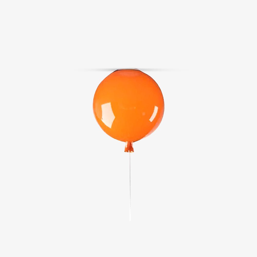 A single orange Clérachic balloon light hangs against a plain white background with its cord trailing down.