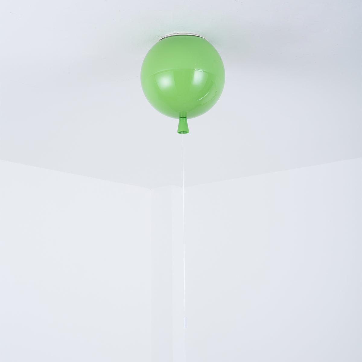 A single green Clérachic balloon light hangs from a plain white ceiling corner in a straightforward product shot.