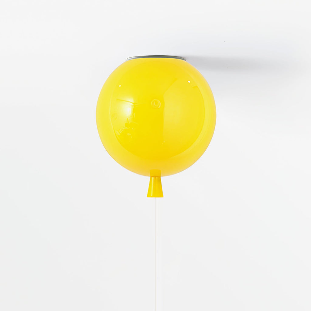 A single yellow balloon-shaped ceiling light from Clérachic hangs against a plain white ceiling, its pull cord dangling below.