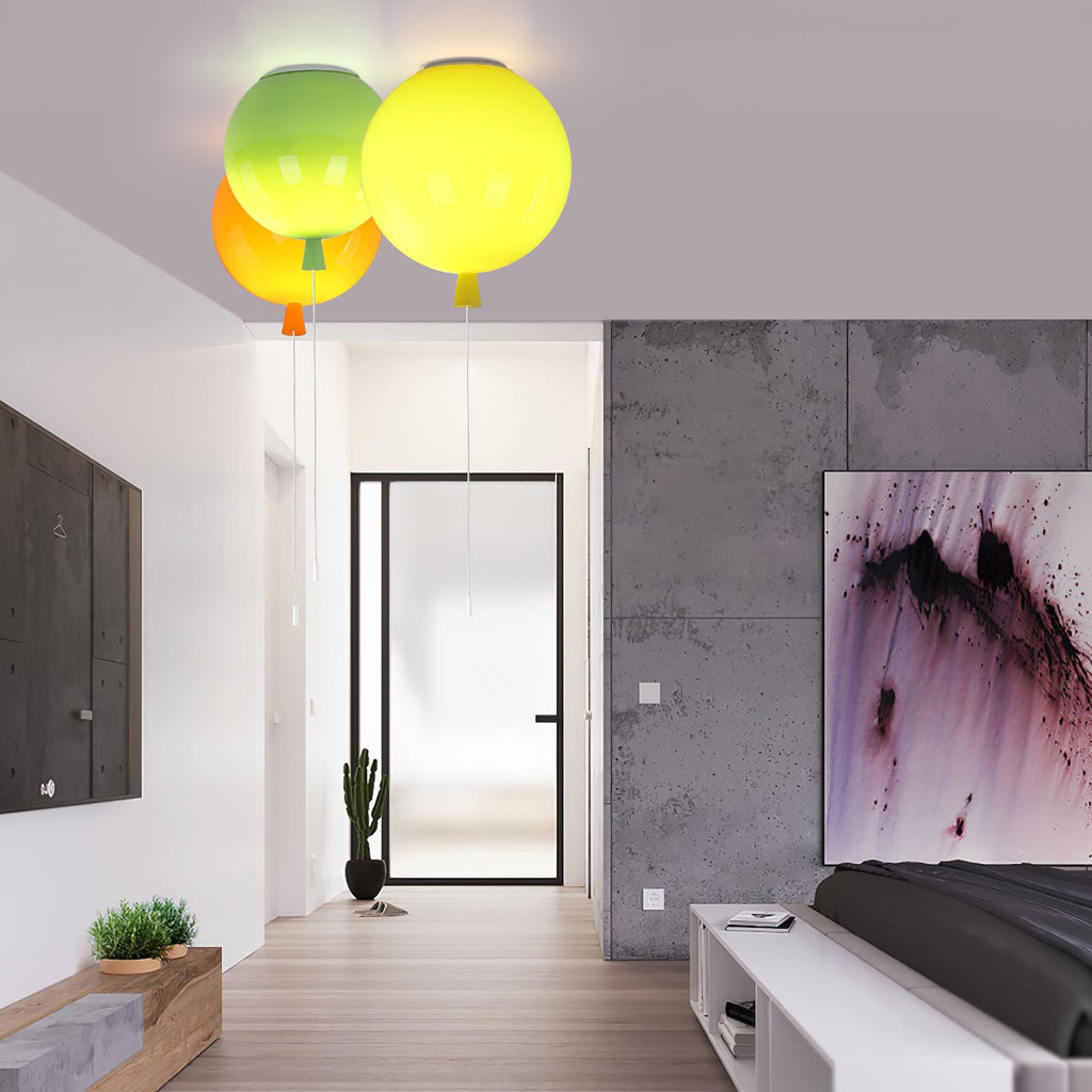 In a hallway with concrete-look walls and a potted cactus, two Clérachic balloon lights in green and yellow hang from the ceiling.