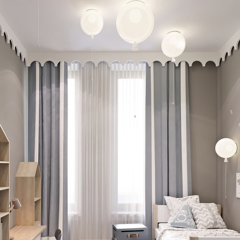 Three white Clérachic balloon lights line a scalloped ceiling edge above striped curtains and a single bed.