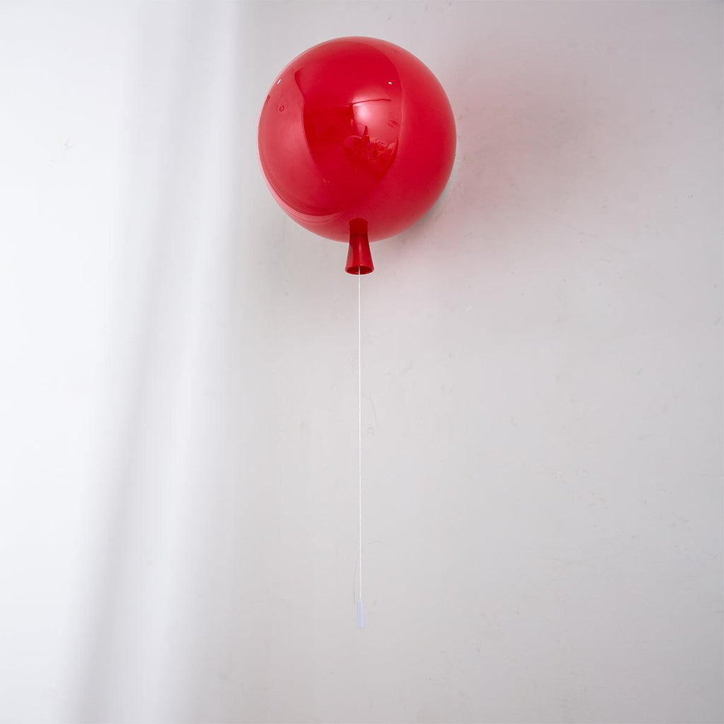 Playful balloon-shaped wall sconce mounted in a room