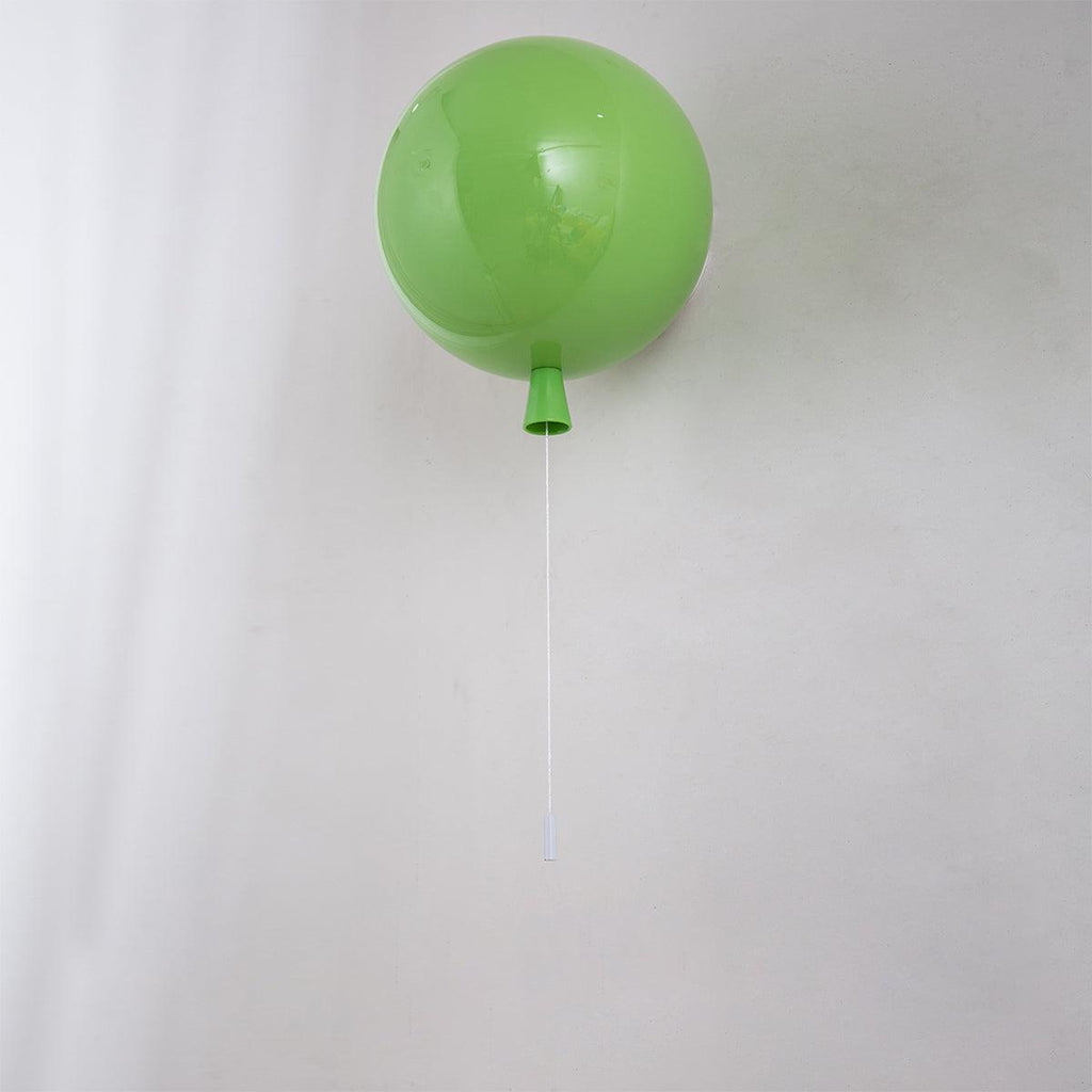 Balloon-shaped wall light glowing in a playful interior