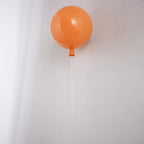 Balloon wall light casting a soft atmospheric glow
