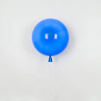 Balloon-shaped wall light with warm glow on a wall