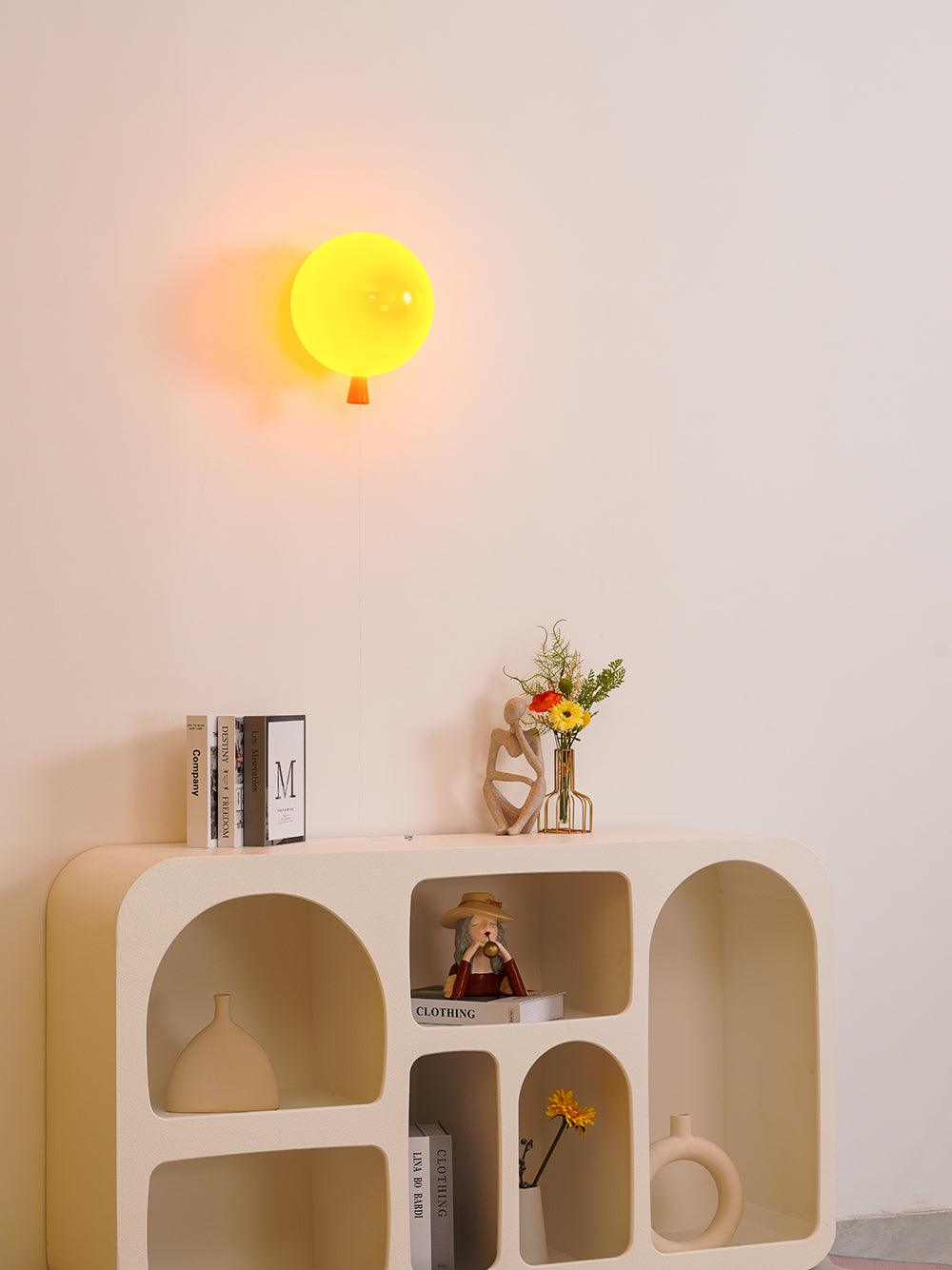 Balloon wall sconce glowing in a softly lit room