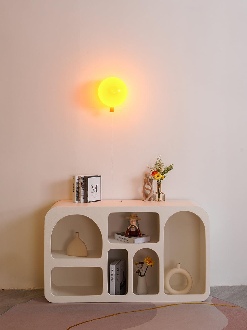 Sculptural balloon wall light with hanging pull cord