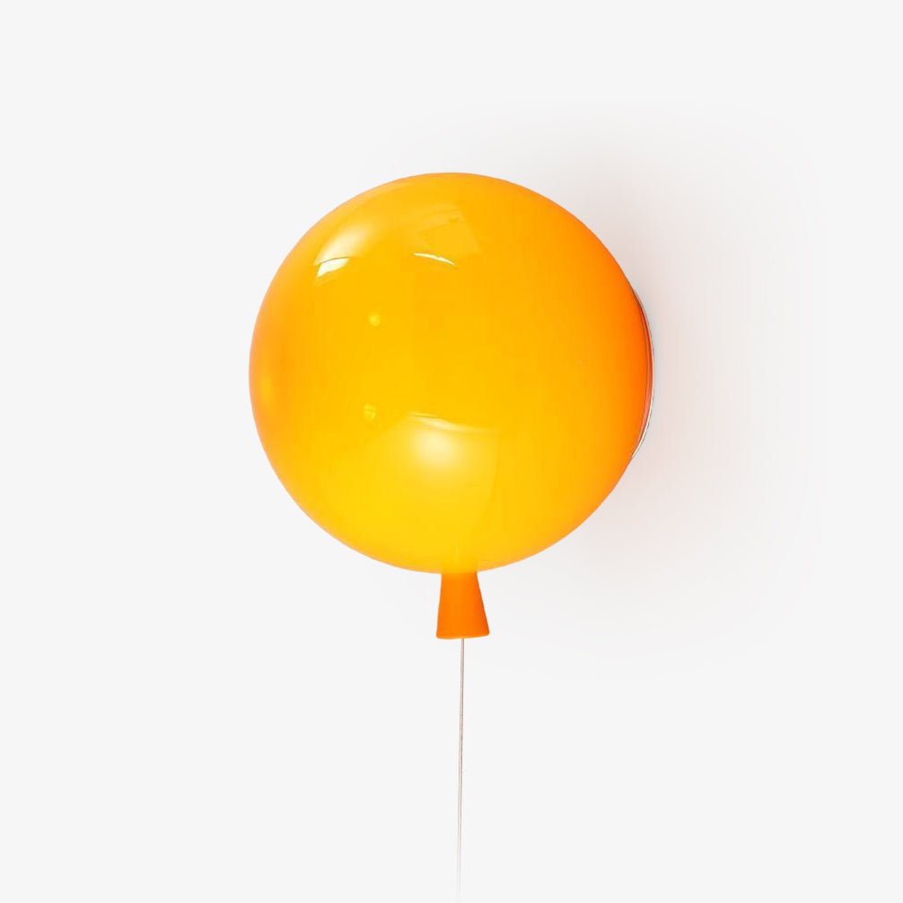 Balloon wall light with rounded polymer shade on a wall