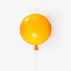 Balloon wall light with rounded polymer shade on a wall