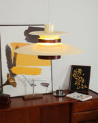 Side angle on the lit beige shades and walnut band of this Clérachic pendant near framed art.