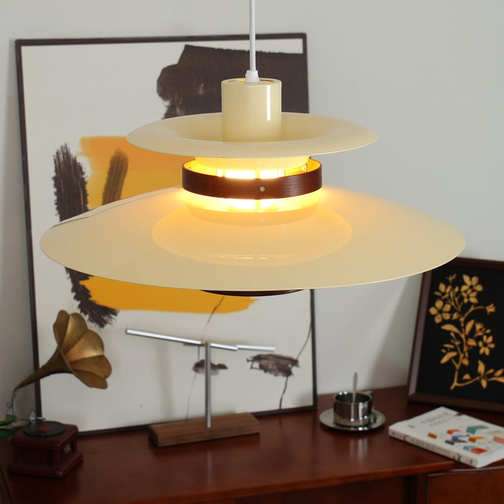 This Clérachic pendant is styled low over a dark wood sideboard beside a gramophone.