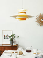 Close view of the beige shades on this Clérachic pendant beside a sunburst wall clock.