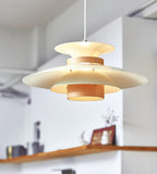 Angled underside view of the lit beige shades and walnut ring on this Clérachic pendant.