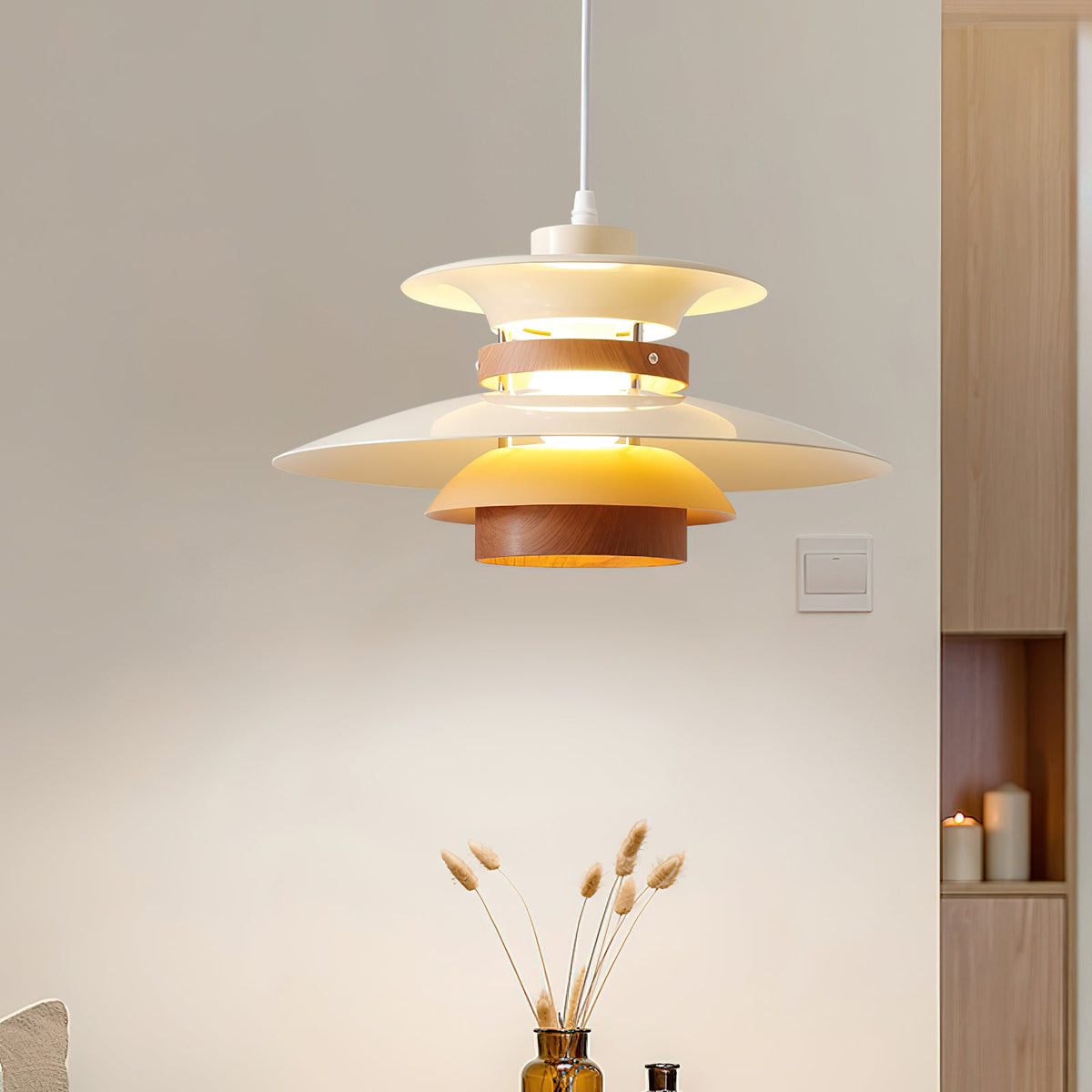 Lit beige shades and walnut rings on this Clérachic pendant against open wood shelving.