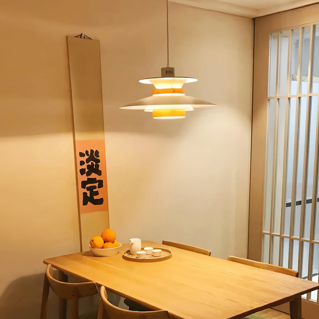 A white Clérachic pendant lights a wooden table in a room with a paper screen door.