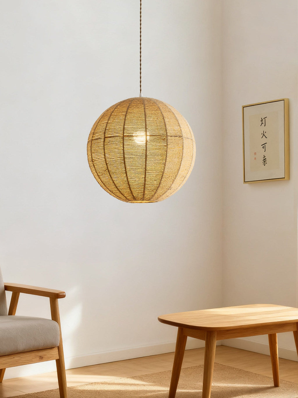 A wood chair and small table furnish a minimalist room lit by this hemp rope Clérachic pendant.
