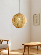 A wood chair and small table furnish a minimalist room lit by this hemp rope Clérachic pendant.