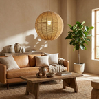 Stone vases and a leather sofa sit near a wood coffee table lit by this hemp rope Clérachic pendant.