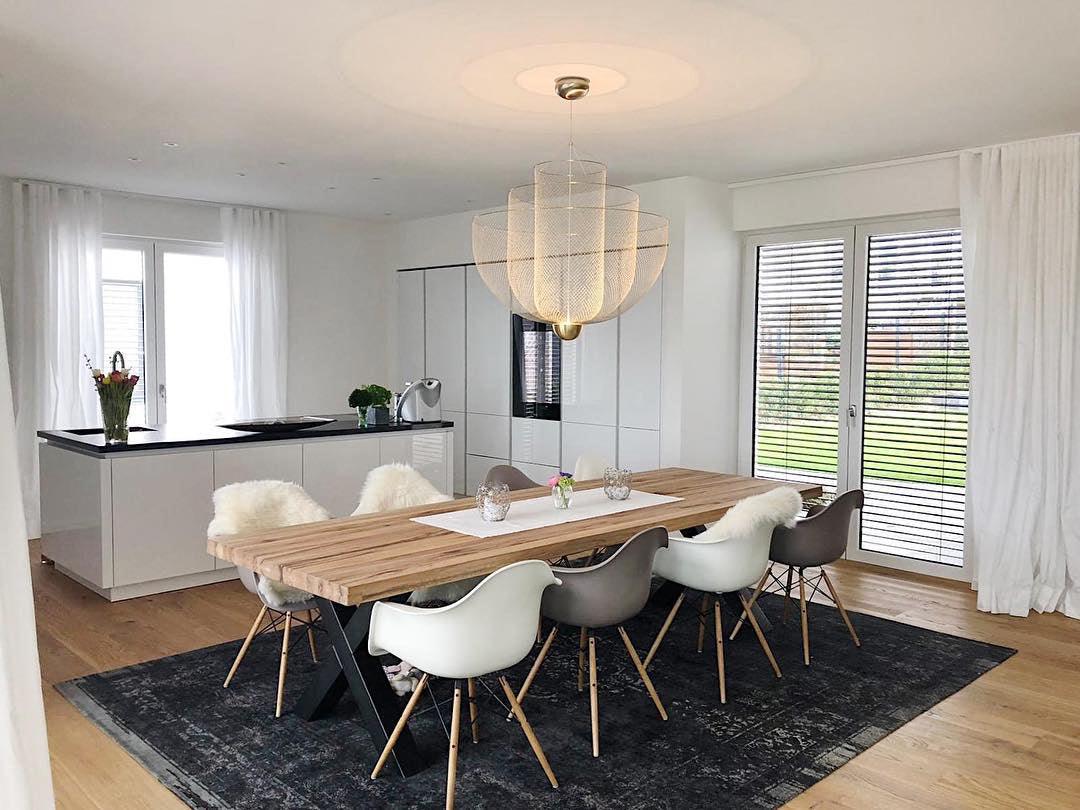 Spherical wire pendant light lit above a seating area