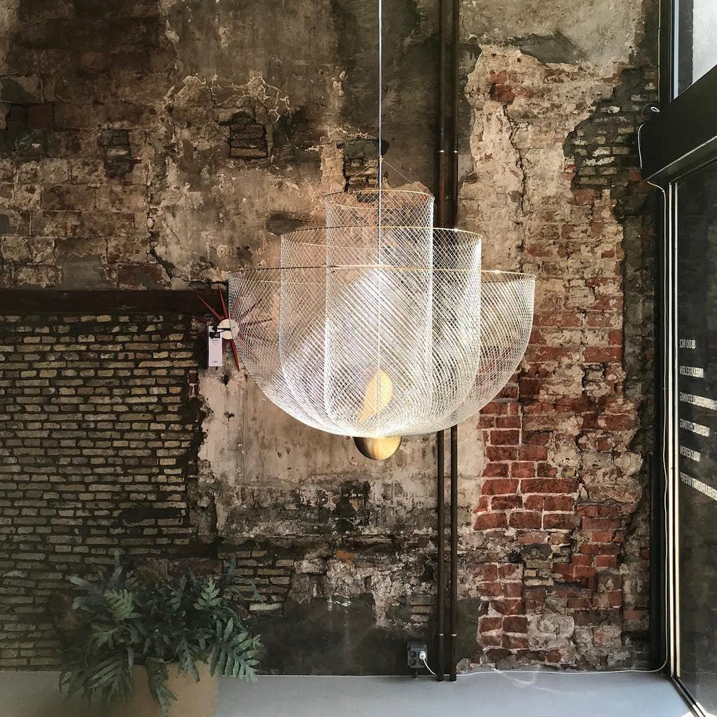 Layered steel wire chandelier style pendant light glowing softly
