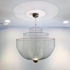 Layered wire pendant light hanging in a bright interior