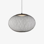 Mesh shade pendant light suspended over a table
