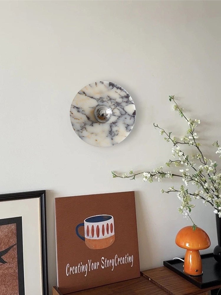 A wider crop of the same corner frames the Clérachic wall light above the console, canvas print, mushroom lamp and blossom spray.