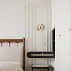 A wider view of the panelled corridor shows the same Clérachic wall light glowing above the cane bench, near a dark screen and door.