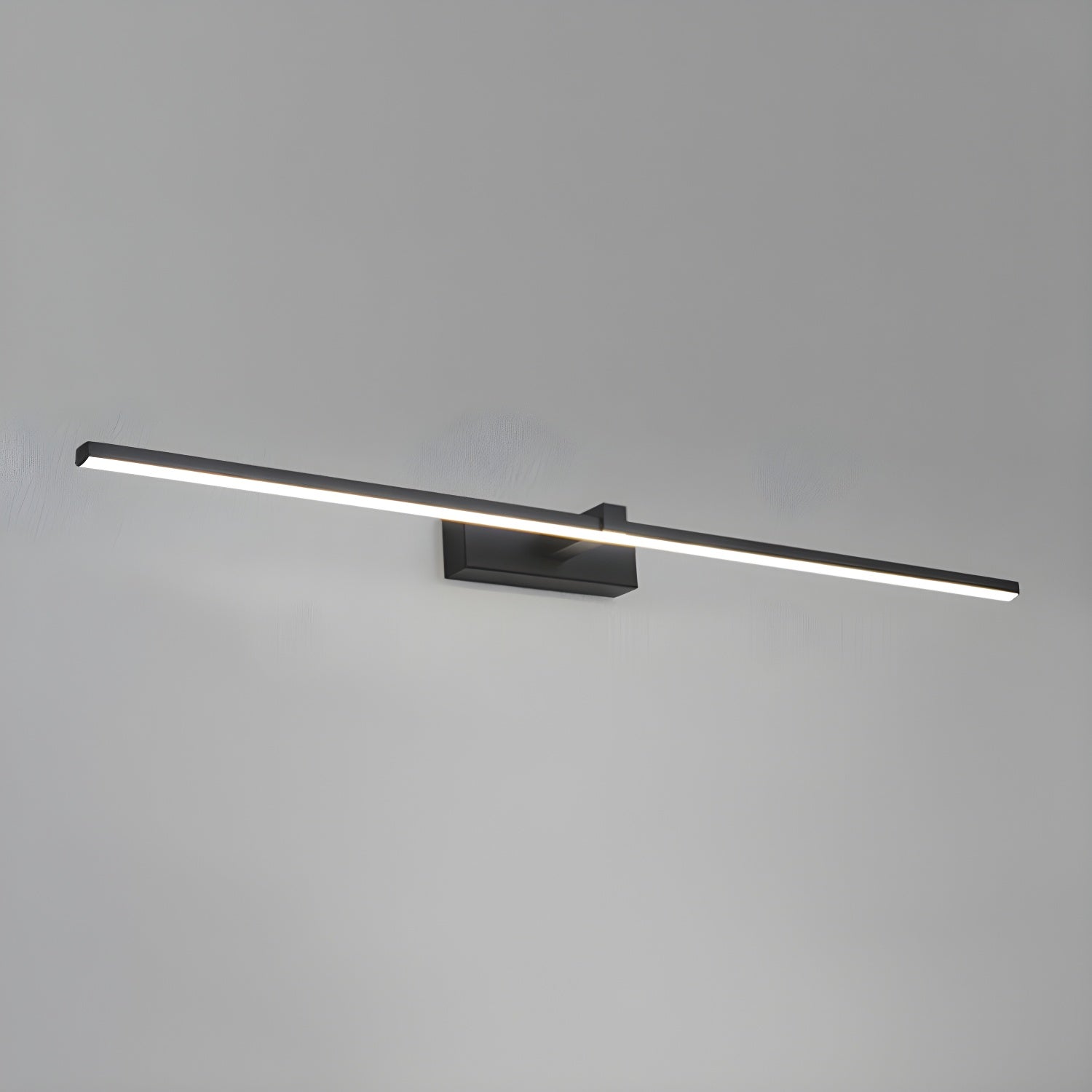 Slim black linear wall light mounted near a mirror