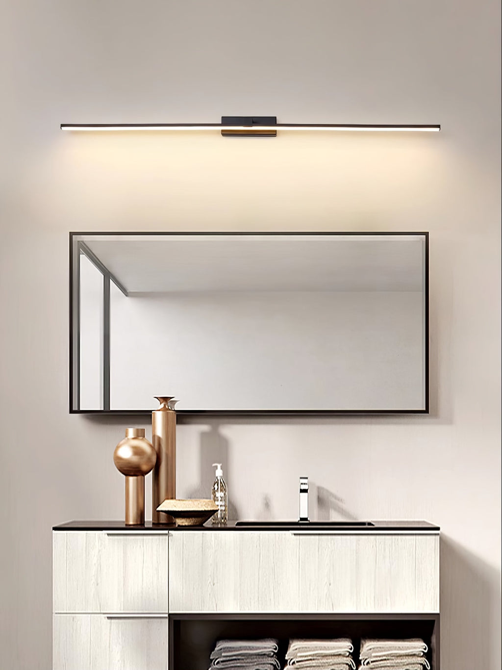 Slim linear LED wall light shown beside a vanity mirror