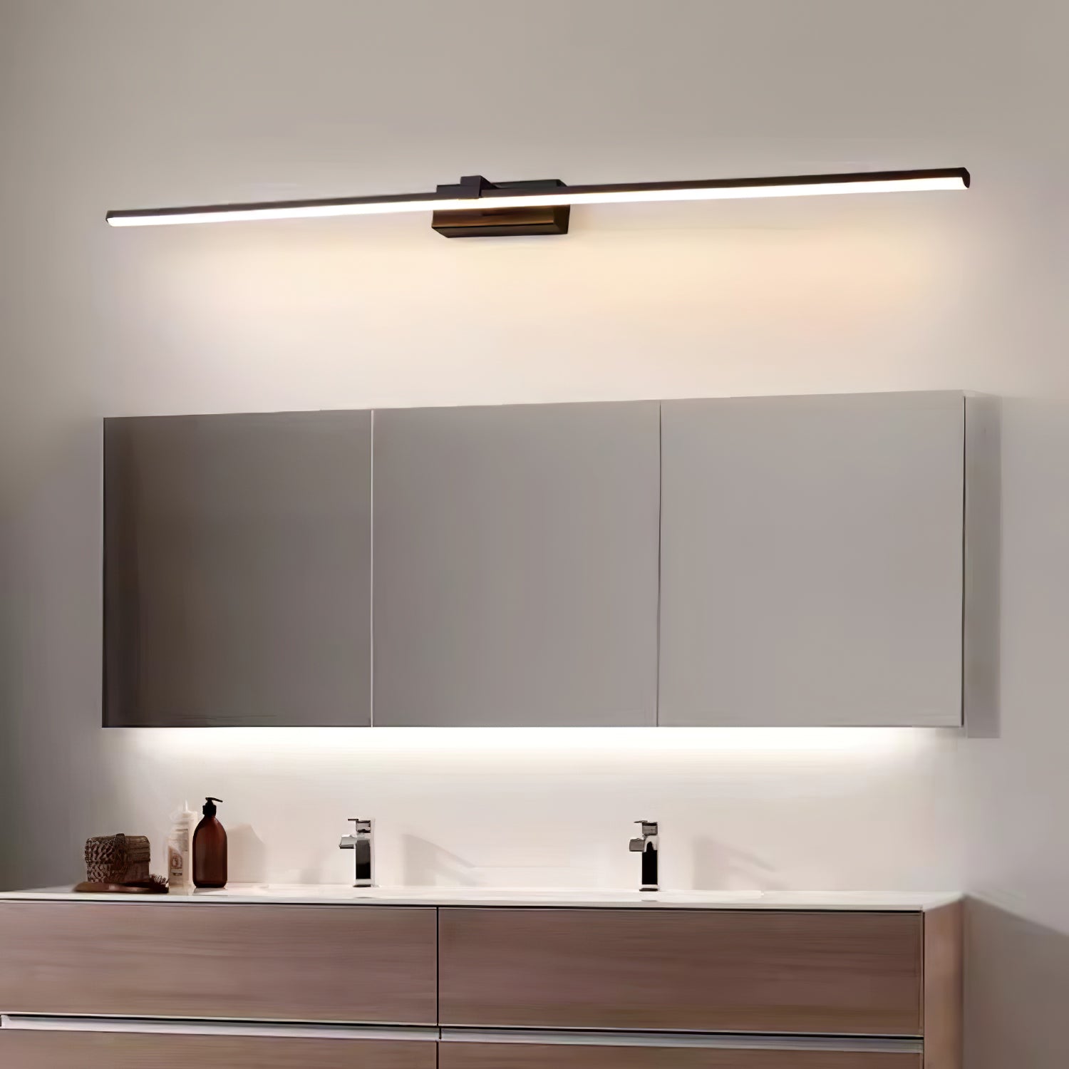 Slim black wall light mounted vertically beside a mirror