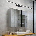 Slim linear wall light glowing above a washbasin
