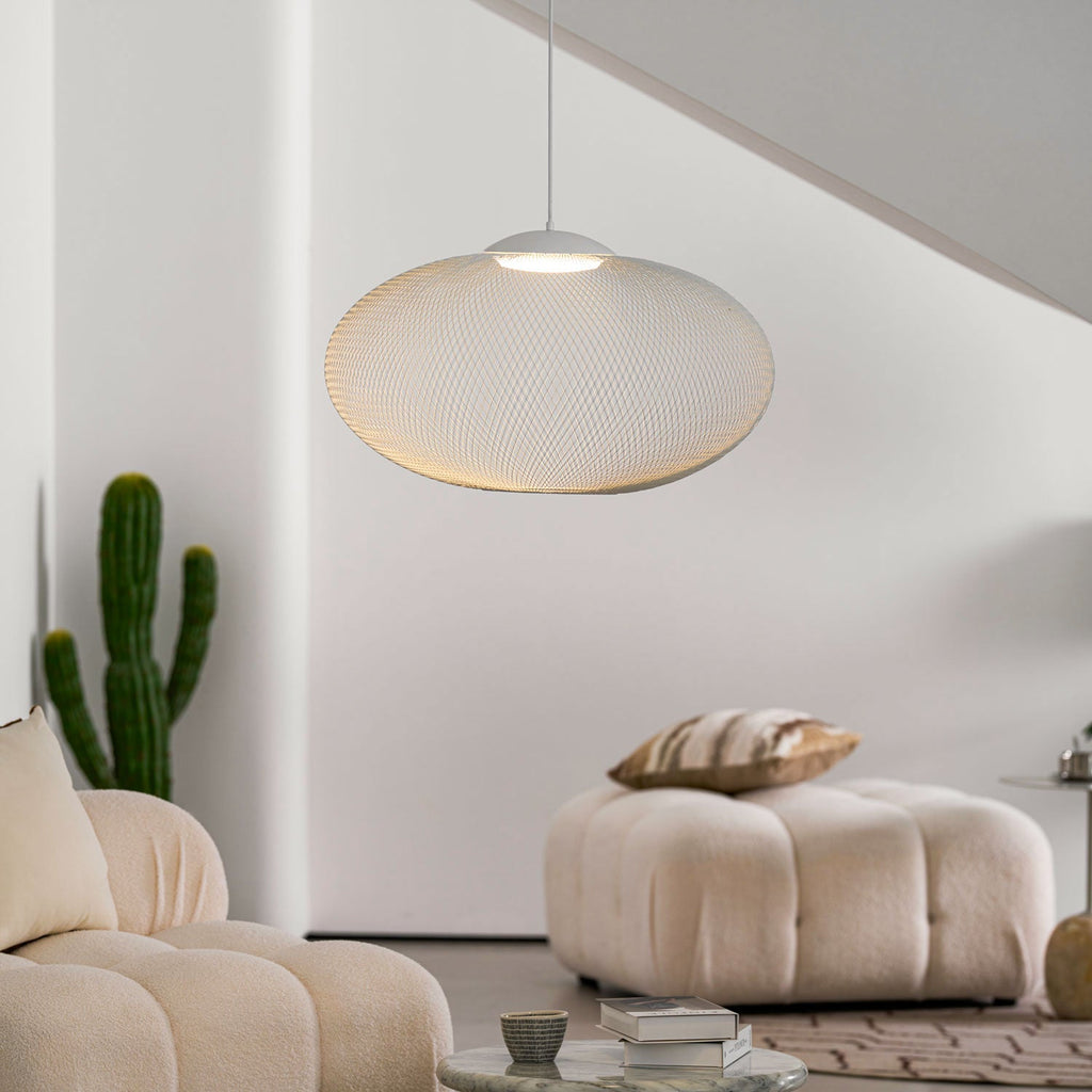 Iron lattice pendant light glowing in a cozy room