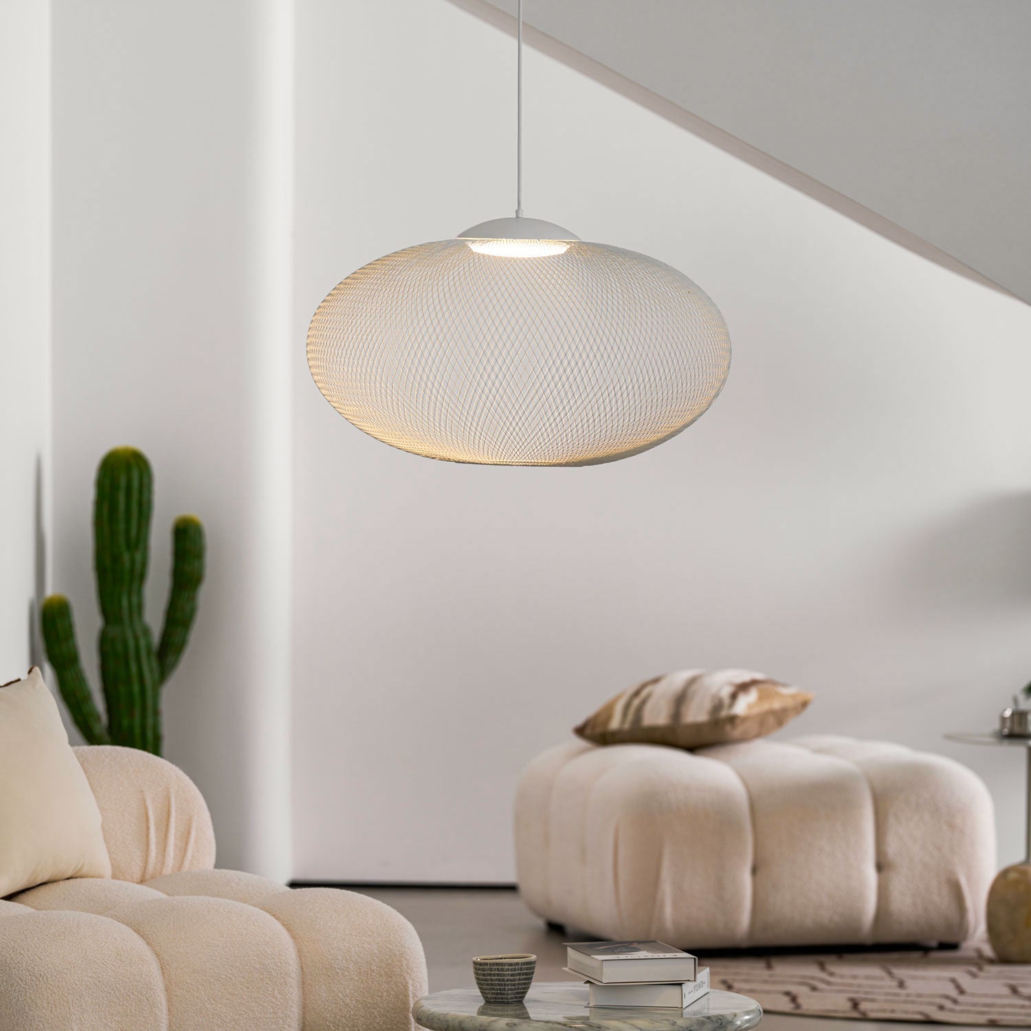 Iron lattice pendant light glowing in a cozy room