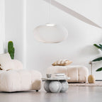 Mesh shade pendant light suspended in a bright space