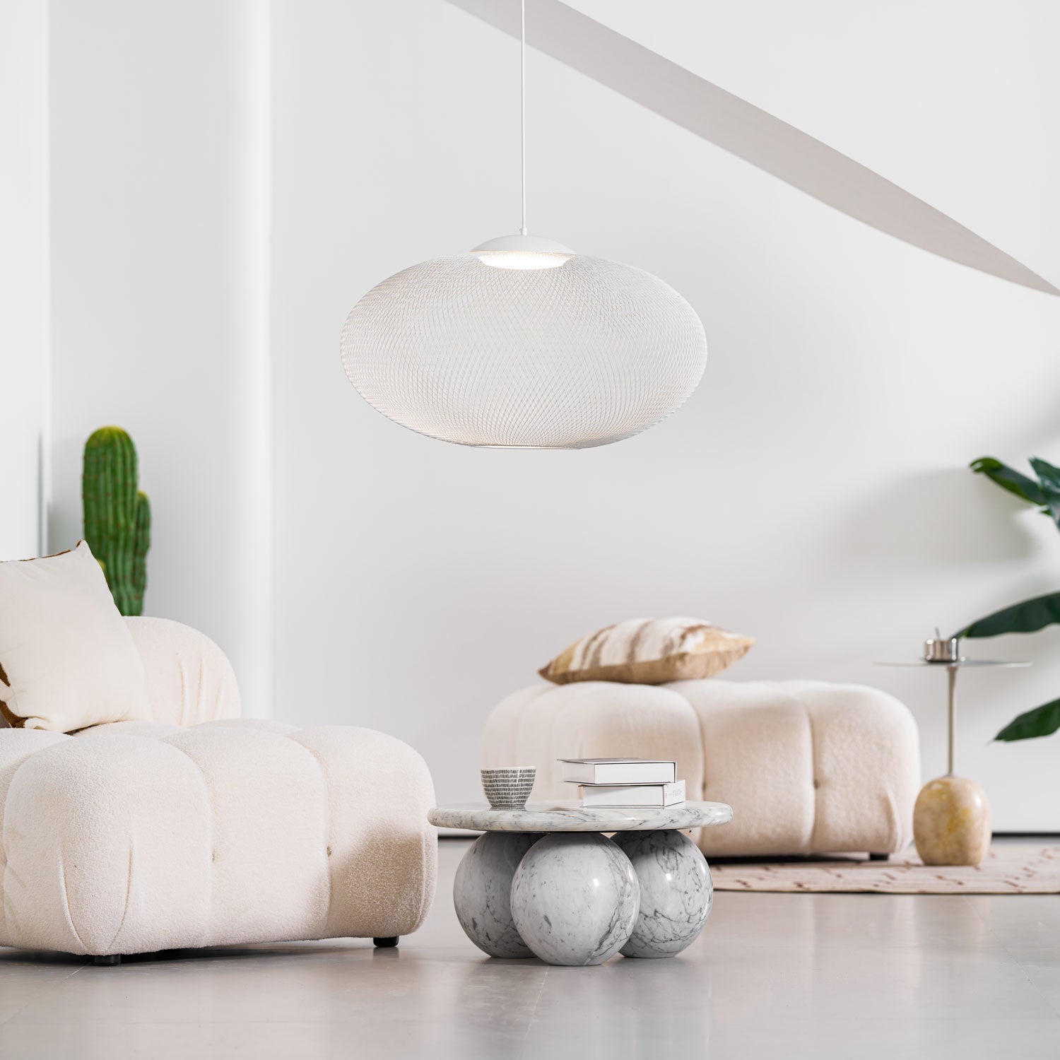 Mesh shade pendant light suspended in a bright space